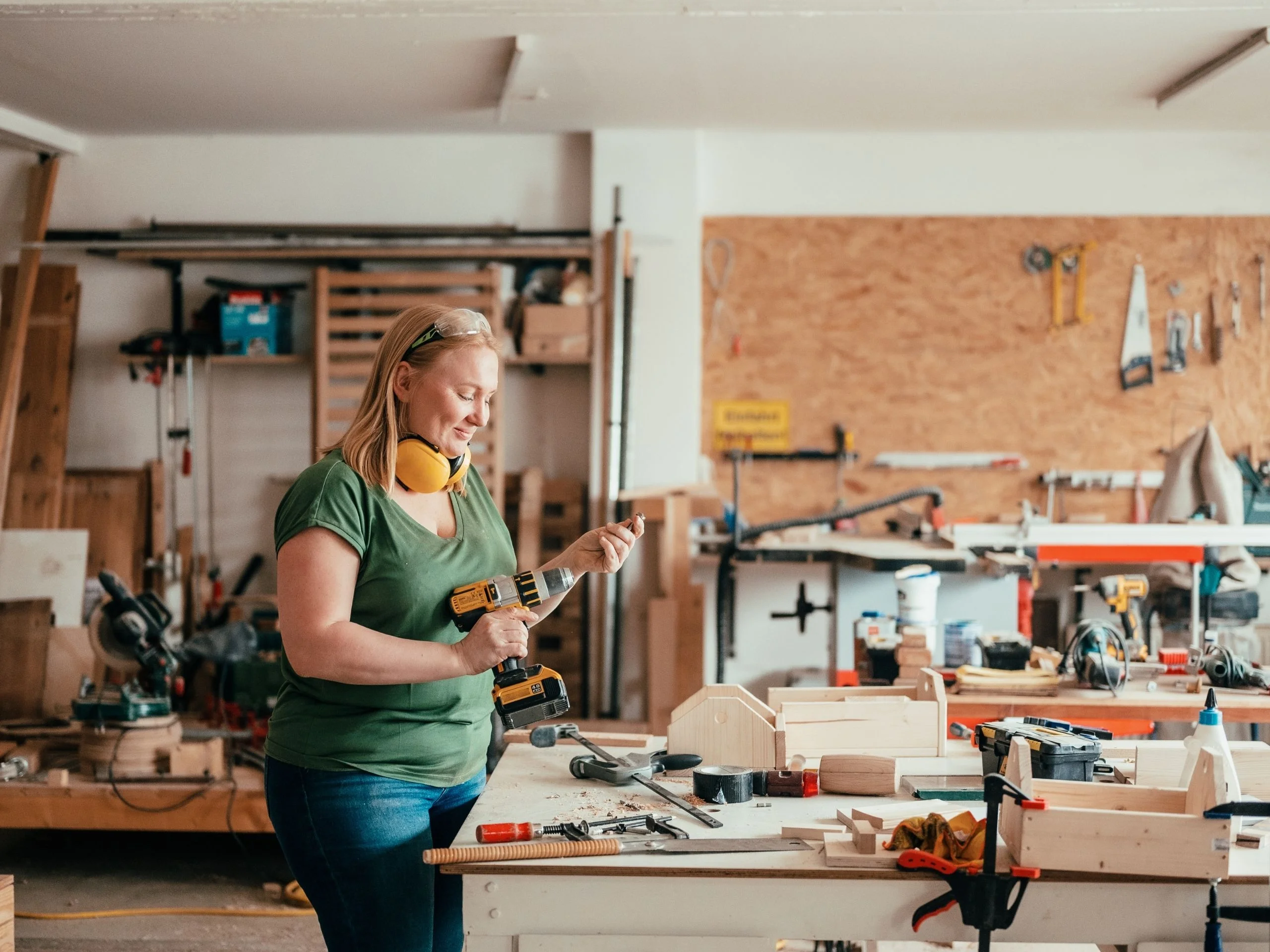 Mujer en taller utilizando un taladro