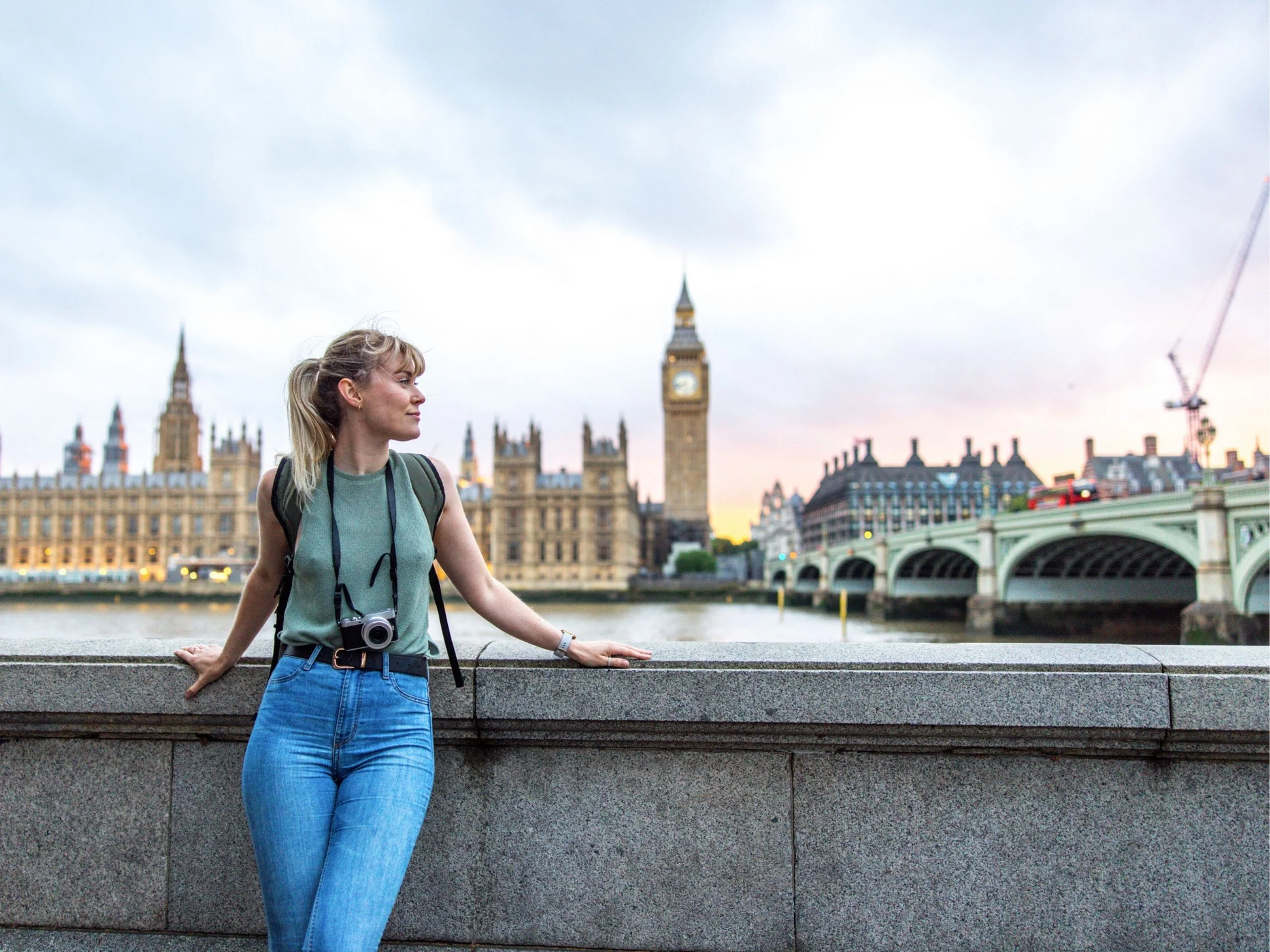 Turista joven adulta posando frente al Palacio de Westminster
